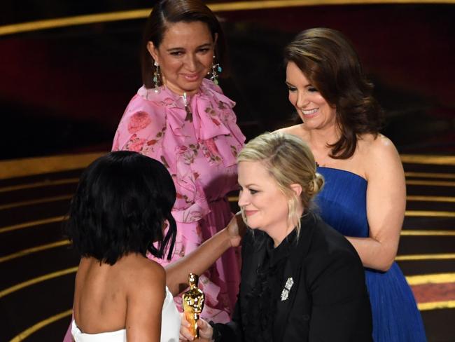 Regina King accepted her Oscar from comedy stars Maya Rudolph, Amy Poehler and Tina Fey. Picture: Getty Images 