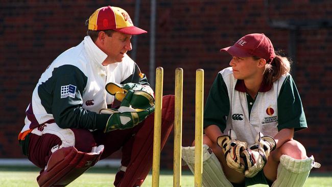 Ian Healy and Julia Price swap ideas for behind the stumps.