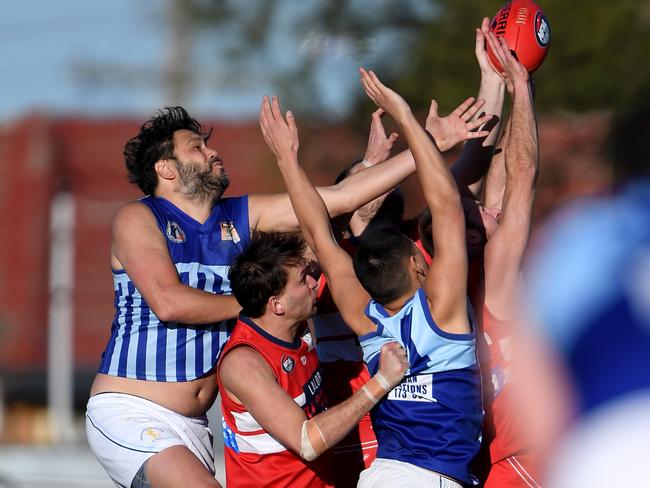 Reservoir and Lalor players fly for a mark. Picture: Andy Brownbill