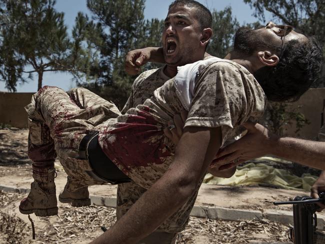 General News - Third Prize, Stories © Alessio Romenzi Title: We Are Not Taking Any Prisoners A fighter of the Libyan forces affiliated to the Tripoli government carries a comrade who was seriously injured just seconds before by a booby trap placed by Islamic State fighters. Story: Sirte, Libya, is one of the three self-proclaimed capitals of the so-called Islamic State, along with Raqqa in Syria and Mosul in Iraq. It was the first of the three to fall, with an offensive launched by the Libyan government in May 2016. It took seven months of fighting, 500 American airstrikes, the lives of 700 Libyan soldiers and more than 3,000 injured Libyan soldiers to finally declare the city free.