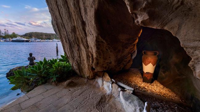 Caves throughout the property and mermaid statue sitting on waterfront.