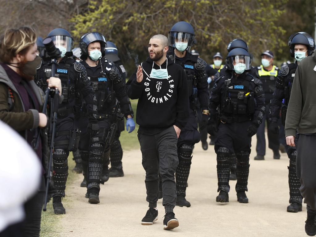 A man is marched away by police. Picture: NCA NewsWire / Daniel Pockett