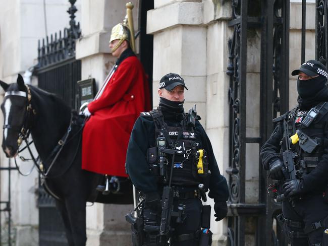 Armed police officers stand guard by a member of the Household cavalry on Whitehall as England enters a second coronavirus lockdown. Picture: AFP