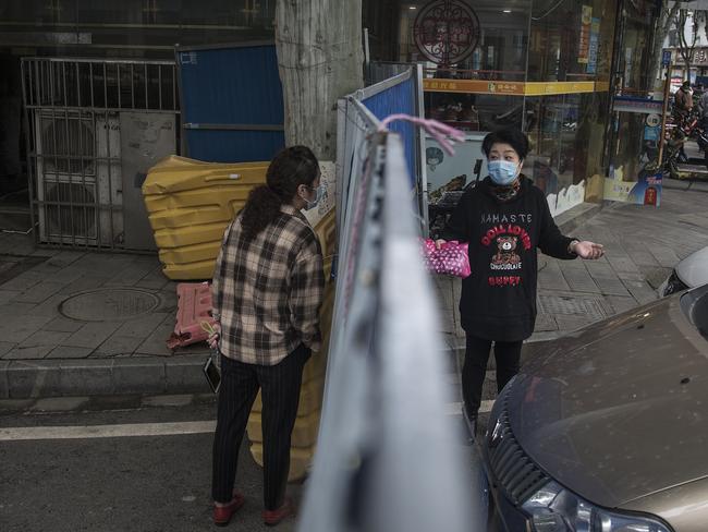 Residents of Wuhan keep a distance. Picture: Getty Images