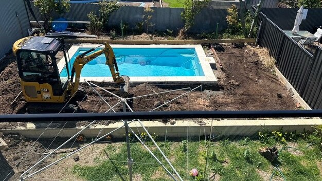 Joshua Jones operating machinery in Ms Hodson’s backyard.