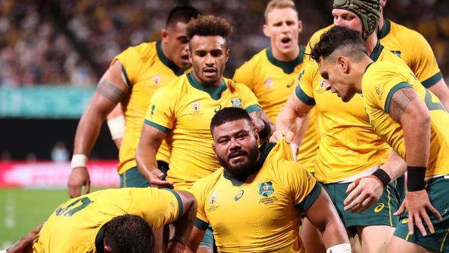 SAPPORO, JAPAN - SEPTEMBER 21: Tolu Latu (C) of Australia is congratulated by his team mates after scoring his side third try during the Rugby World Cup 2019 Group D game between Australia and Fiji at Sapporo Dome on September 21, 2019 in Sapporo, Hokkaido, Japan. (Photo by Mark Kolbe/Getty Images)