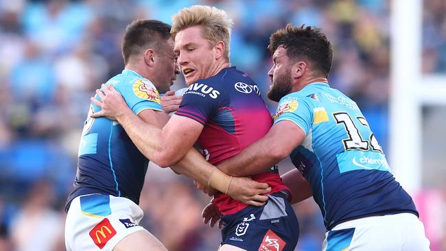 Tom Dearden is tackled during the round 22 NRL match between Gold Coast Titans and North Queensland Cowboys. (Photo by Chris Hyde/Getty Images)