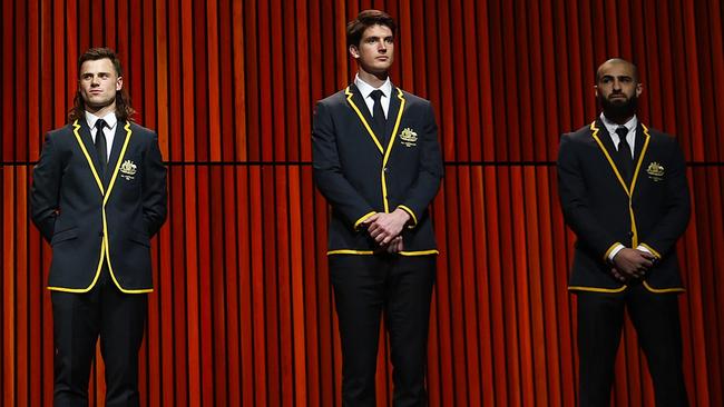 New Giants club champion Sam Taylor (middle) was picked in the All-Australian backline on Wedbndday, alongside the likes if Jack Snclair (left) and Getty Images