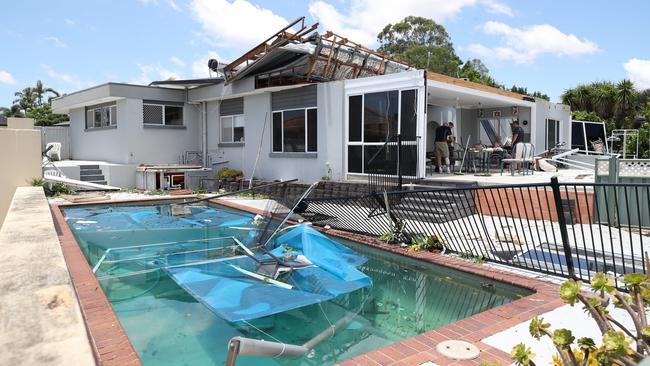 Residents survey the damage at Helensvale caused by wild weather on Christmas night in 2023.