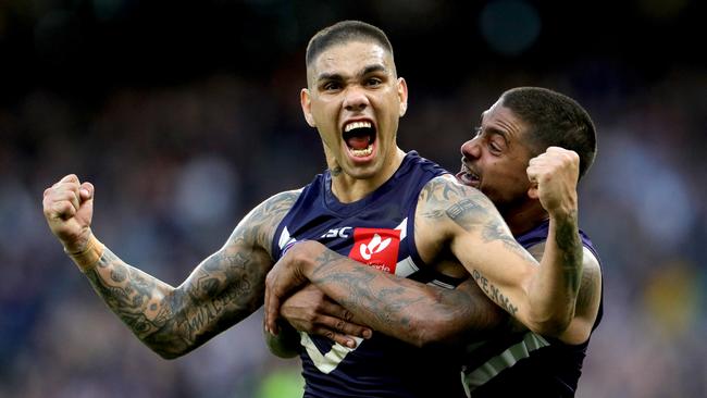 Michael Walters is lifted by Brad Hill after his best on ground performance in Fremantle’s win. Picture: AAP Image/Richard Wainwright.