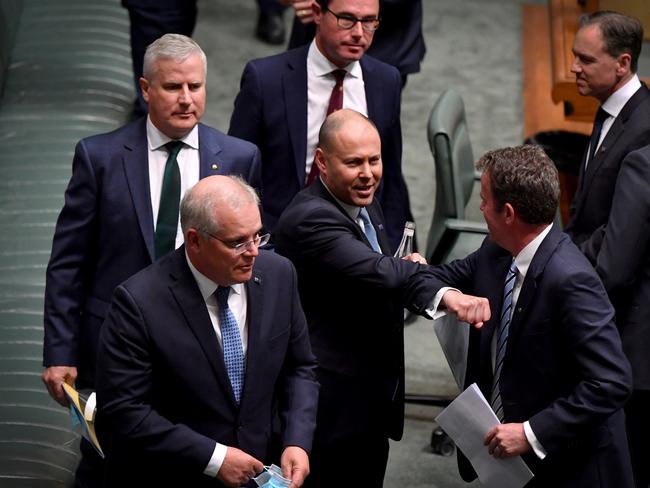 Scott Morrison (L) departs as Treasurer Josh Frydenberg reacts after the budget delivery in the House of Representatives. Picture Getty Images.