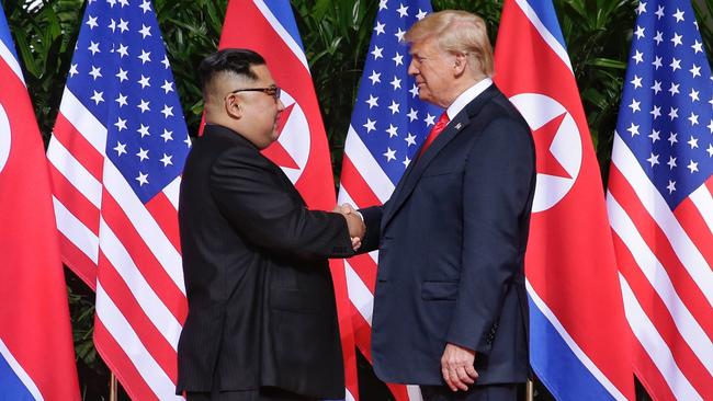 North Korean leader Kim Jong-un (left) shakes hands with US President Donald Trump during their historic U.S.-DPRK summit at the Capella Hotel in Singapore on June 12, 2018. Picture: Getty Images