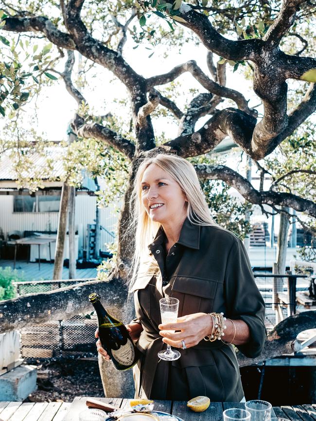 Collette Dinnigan on Champagne duty at the oyster farm. Picture: Felix Forest