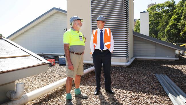 Tony Abbott hears about the Bear Cottage upgrade from site manager Col Weaver. Picture: Braden Fastier