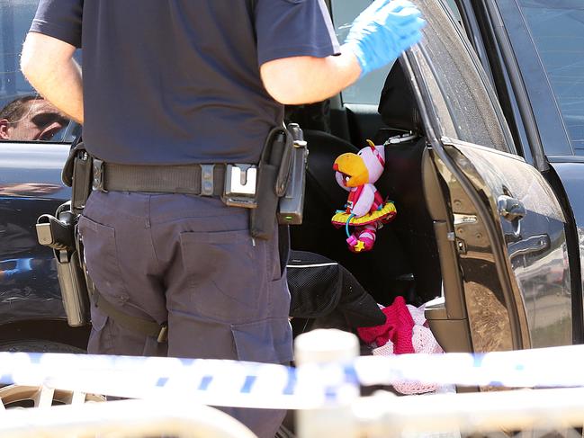 Part of a baby seat and children’s toys can be seen in the back seat of the car where the children were found. Picture: Lyndon Mechielsen