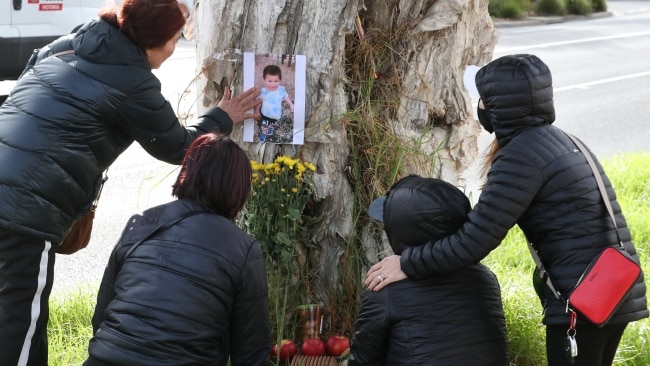 Ethan's family place toys flowers and food at a makeshift memorial on the side of the road. Picture: David Crosling