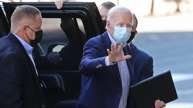 Joe Biden acknowledges journalists as he enters a venue in Wilmington, Delaware for a live video 'town hall' campaign event. Picture: Getty Images