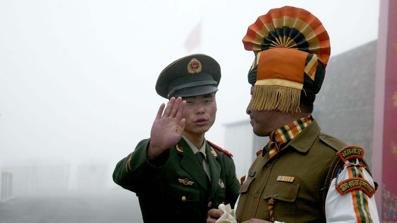 A Chinese soldier (left) next to an Indian soldier at the Nathu La border crossing between India and China in India’s northeastern Sikkim state, in 2008. Picture: Diptendu Dutta/AFP