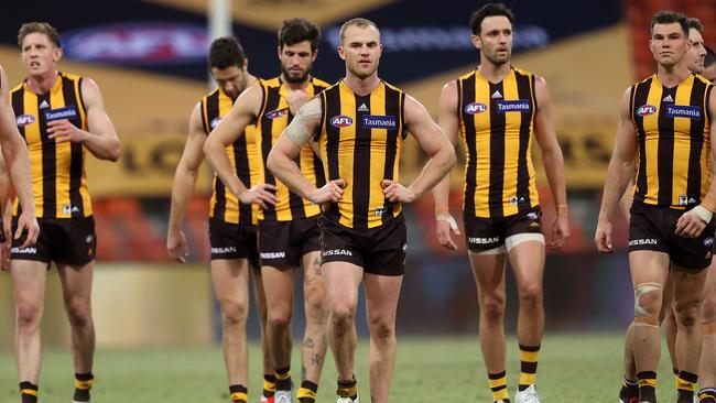 Dejected Hawks leave the field after losing to the Demons at Giants Stadium. Picture: Phil Hillyard