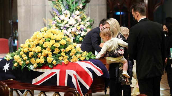 Bert Newton’s daughter Lauren with family arrive, as Lauren’s daughter reaches out to tough Bert’s coffin. Picture: David Caird