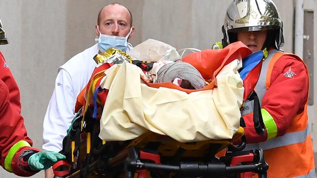 French firefighters load one of the injured into an ambulance. Picture: AFP