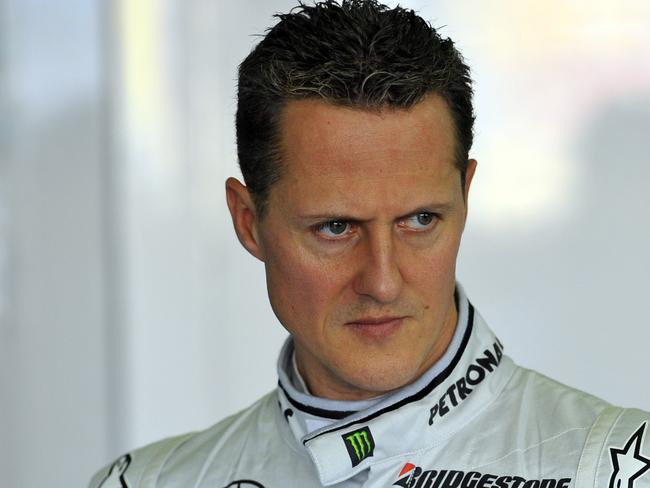 German driver Michael Schumacher prepares for practice in the Mercedes garage at the Albert Park Street Circuit at the Australian Formula One Grand Prix in Melbourne, Friday, March 26, 2010. The Australian F1 GP, the second race of the 2010 season will run on Sunday, March 28. (AAP Image/Julian Smith) NO ARCHIVING, INTL OUT