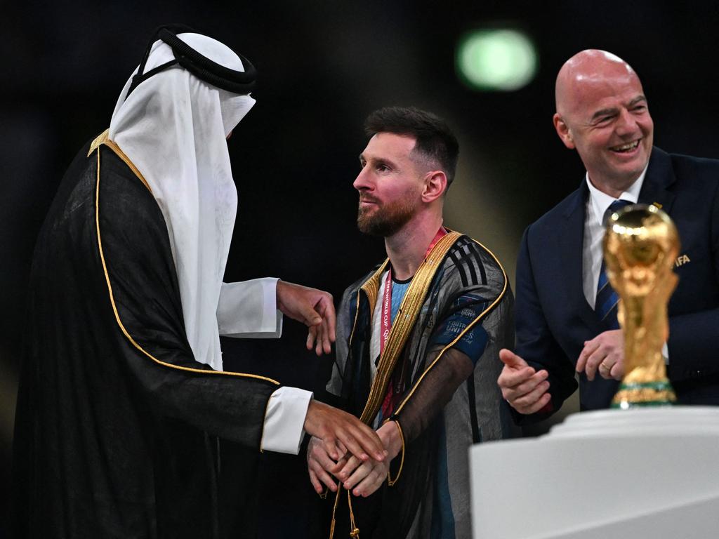 What was Lionel Messi wearing during the World Cup 2022 trophy