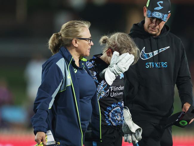 SYDNEY, AUSTRALIA - OCTOBER 29: Bridget Patterson of the Strikers is helped from the field after being struck by a ball during the WBBL match between Sydney Sixers and Adelaide Strikers  at North Sydney Oval on October 29, 2024, in Sydney, Australia. (Photo by Mark Metcalfe/Getty Images)