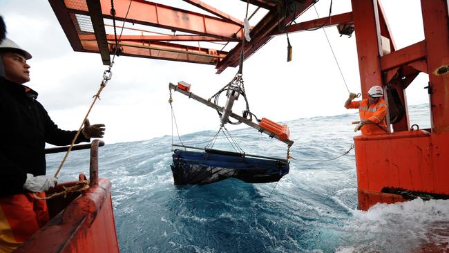 The trawl deck crew on board Aurora Australis release a trawl net into the Southern Ocean, Friday, Jan. 6, 2012. The trawl net was being used by a research team from the Antarctic Climate and Ecosystems Co-operative Research Centre to collect Foraminifera and Pteropods, shelled organism barely visible to the human eye, during a marine science voyage to the Antarctic. (AAP Image/Dean Lewins) NO ARCHIVING