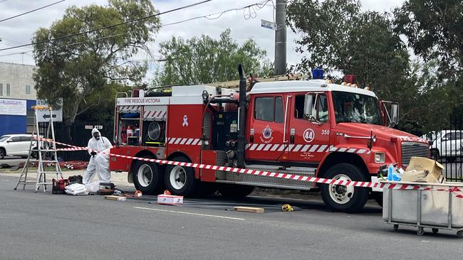 Investigators clean off near a fire truck. Picture: Nilsson Jones.