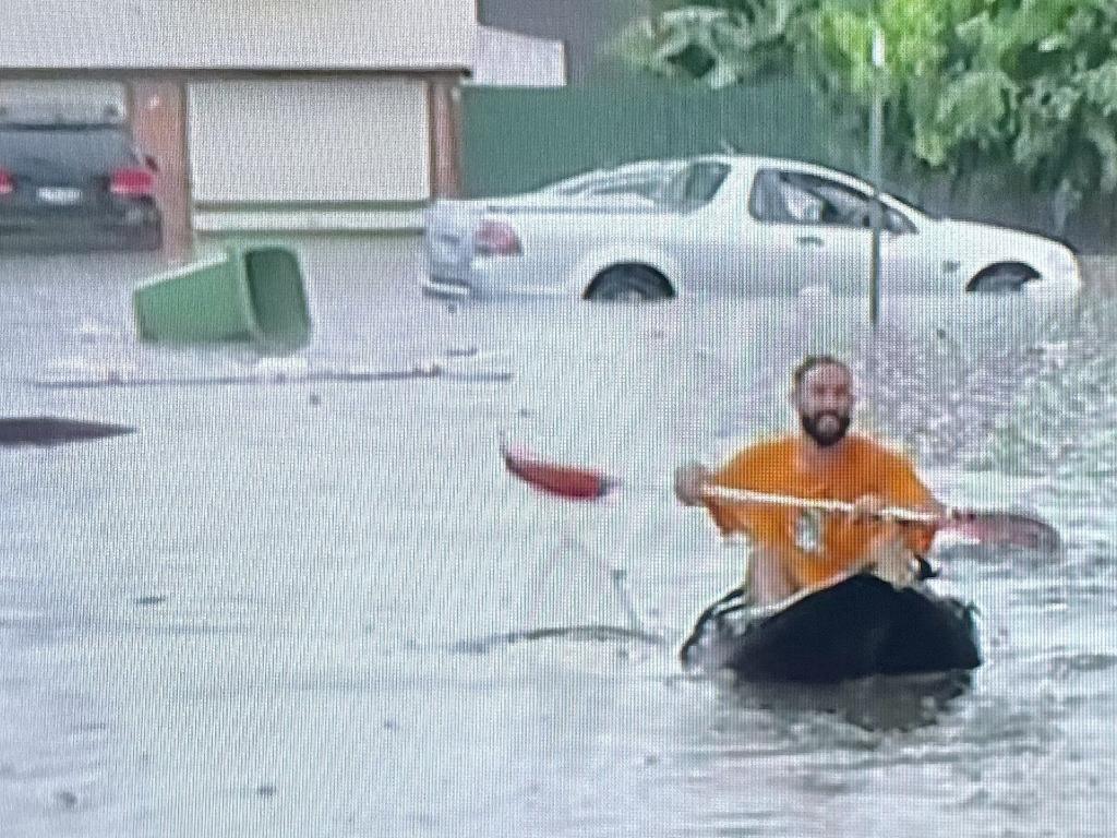 A man paddles to safety in Bray Park, Moreton Bay. Picture: QAS