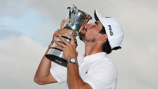 Joaquin Niemann of Chile kisses the Stonehaven Cup after winning the Australian Open. (Photo by Mark Metcalfe/Getty Images)