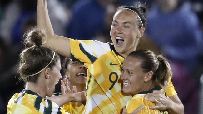 Matildas players celebrate Caitlin Foord’s (centre) stunning strike against the US on Friday. Picture: AP 