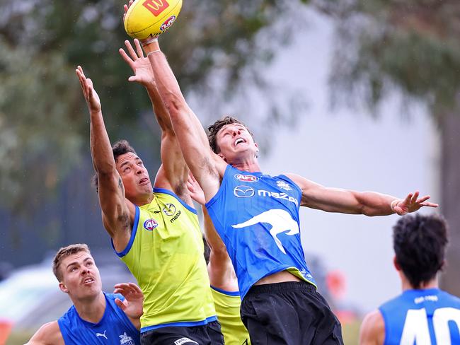 Charlie Comben (right) flies at North Melbourne training. Picture: Mark Stewart