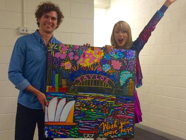 Vance Joy presents Taylor Swift with the artwork.