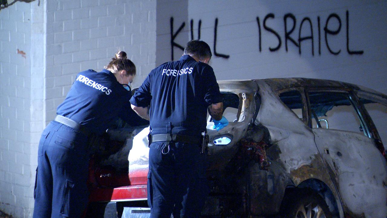 Police inspect a car torched at Magney St, Woollahra. Picture: Onscene Bondi.