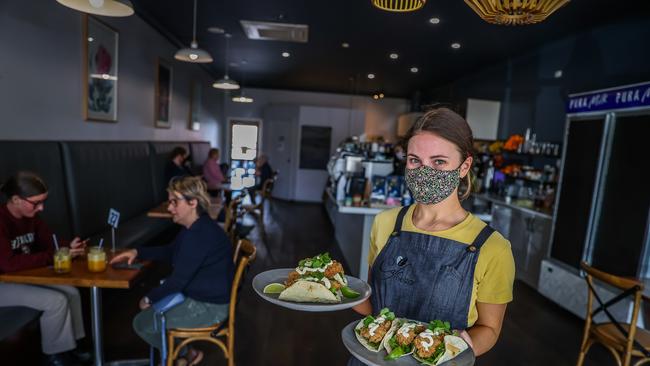 Cafe Melzar worker Laura Wagner in Mount Gambier, where strict restrictions have been imposed – but may soon be lifted. Picture: Tom Huntley