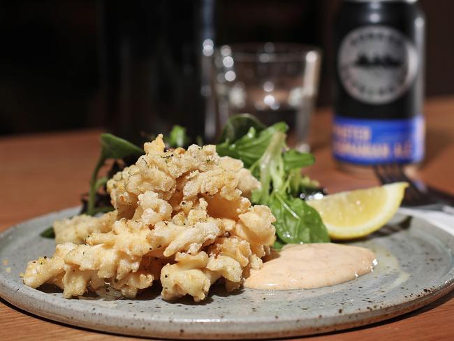 The salt and pepper calamari, served with dressed leaves, paprika mayo and lemon. Picture: LUKE BOWDEN