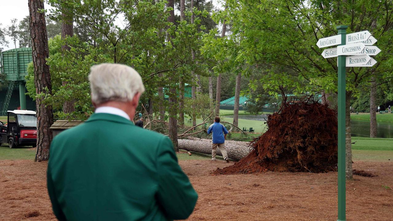 An Augusta National Golf Club member looks over a fallen tree on the 17th hole. Picture: Patrick Smith
