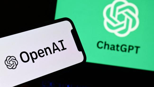 A smartphone and a laptop displaying the logos of the artificial intelligence OpenAI research laboratory and ChatGPT robot. (Photo by MARCO BERTORELLO / AFP)