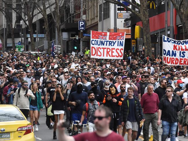 Protesters march through the streets during an anti-lockdown rally in Melbourne on August 21, 2021 as the city experiences it's sixth lockdown while it battle an outbreak of the Delta variant of coronavirus. (Photo by William WEST / AFP)