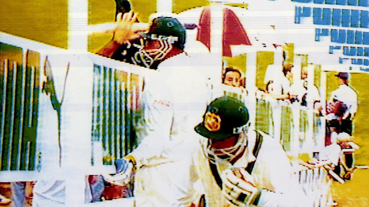 Merv Hughes (left) lashed out at a heckler during the 1994 Australia vs. South Africa match in Johannesburg. Picture: Channel 9