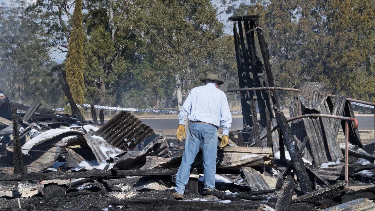 Resident priest Father Dave O'Connor searches the ruins of St Leo's Catholic Church destroyed by fire in Haden. Sunday, 7th Jun, 2020.