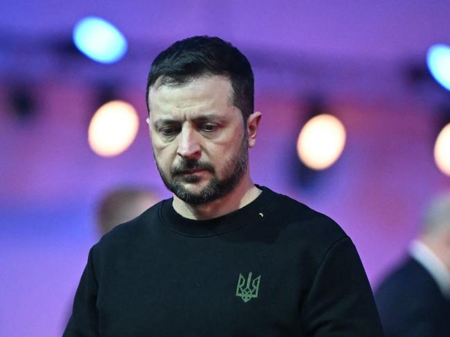 Ukrainian President Volodymyr Zelensky arrives to place a votive candle in front of the train car, the symbol of the event, to pay tribute to the victims during commemorations on the 80th anniversary of the liberation of the German Nazi concentration and extermination camp Auschwitz-Birkenau by the Red Army, in Oswiecim, Poland on January 27, 2025. (Photo by Sergei GAPON / AFP)