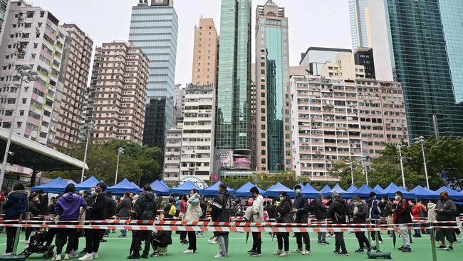 People queue up for Covid-19 tests at a sports ground in Hong Kong as the city faces its worst coronavirus wave to date. Picture: AFP.