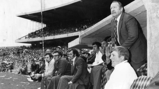 Sturt coach Jack Oatey jumps out of the coaches box to yell instructions at his players during the 1974 grand final against Glenelg at Football Park.