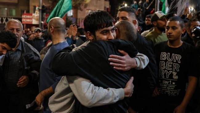 A Palestinian prisoner (left) is welcomed by a relative after being released from Israeli jails in exchange for hostages released by Hamas from the Gaza Strip. Picture: Ahmad Gharabli/AFP