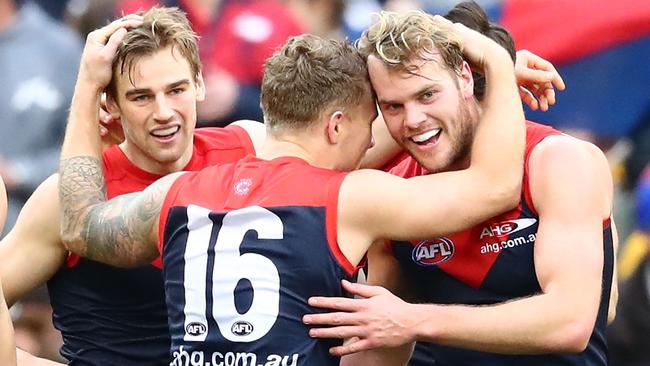 MELBOURNE, AUSTRALIA — AUGUST 06: Dom Tyson of the Demons celebrates with Jack Watts and Sam Weideman of the Demons of the Demons after kicking a goal in the final quarter during the round 20 AFL match between the Melbourne Demons and the Hawthorn Hawks at Melbourne Cricket Ground on August 6, 2016 in Melbourne, Australia. (Photo by Scott Barbour/Getty Images)