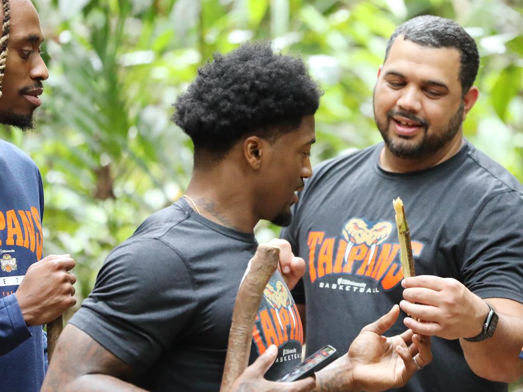 Cairns assistant coach Kerry Williams, right, with Taipans Tahjere McCall and Patrick Miller. Picture: Brendan Radke