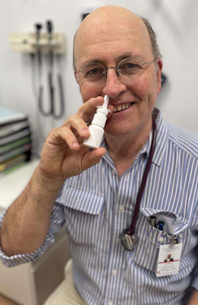 Professor Don Campbell taking a nasal spray that might help prevent catching coronavirus. Picture: Supplied.